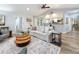 Comfortable living room with wood floors, ceiling fan, and open to the kitchen at 66 Bay Woods Dr, Safety Harbor, FL 34695