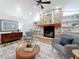 Charming living room with brick fireplace, built-in shelves, and stylish furnishings at 66 Bay Woods Dr, Safety Harbor, FL 34695
