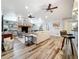 Living room featuring a brick fireplace, built-in bookshelves, vaulted ceiling, and wood floors at 66 Bay Woods Dr, Safety Harbor, FL 34695