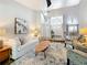 Inviting living room featuring wood-look tile flooring, neutral decor, and an open view to the dining area at 66 Bay Woods Dr, Safety Harbor, FL 34695