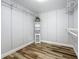 Spacious walk-in closet with custom shelving and organizers, and wood-look floor at 66 Bay Woods Dr, Safety Harbor, FL 34695