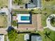 Aerial view of backyard featuring a stunning pool, patio area, and meticulously maintained landscaping at 715 39Th Ne Ave, St Petersburg, FL 33703