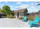 Backyard shed with chairs and greenery sits on a stone patio at 715 39Th Ne Ave, St Petersburg, FL 33703