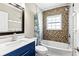 Modern bathroom features a decorative-tiled shower, vanity, and ample lighting at 715 39Th Ne Ave, St Petersburg, FL 33703
