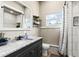 Modern bathroom with vanity, black hardware, stylish mirror, and shower at 715 39Th Ne Ave, St Petersburg, FL 33703