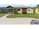 Charming single-story home with a well-manicured lawn, beautiful landscaping, and a welcoming front porch at 715 39Th Ne Ave, St Petersburg, FL 33703