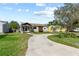 Charming home with a large tree, lovely landscaping, and a long curving driveway at 715 39Th Ne Ave, St Petersburg, FL 33703