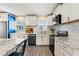 This bright kitchen offers stainless appliances, white cabinets, and sleek marble countertops at 715 39Th Ne Ave, St Petersburg, FL 33703