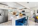 Stylish kitchen with a breakfast bar, stainless steel appliances, white cabinets and wood-look floors at 715 39Th Ne Ave, St Petersburg, FL 33703