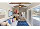 Bright living room showcasing fireplace, ceiling beams, and glass doors to pool area at 715 39Th Ne Ave, St Petersburg, FL 33703