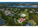 Aerial view of a luxury home in a beautiful community near a lake and lush landscaping at 7713 Still Lakes Dr, Odessa, FL 33556