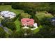 A captivating aerial perspective of a residence on a large, beautifully landscaped lot, featuring a circular driveway at 7713 Still Lakes Dr, Odessa, FL 33556