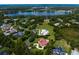 Aerial view of the property showcasing the lake and surrounding neighborhood at 7713 Still Lakes Dr, Odessa, FL 33556