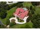 Aerial view of the property highlighting lush landscaping, circular driveway, and a private backyard with a pool at 7713 Still Lakes Dr, Odessa, FL 33556
