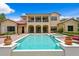 Luxury home featuring a pristine pool, spa, covered patio, and well-manicured garden at 7713 Still Lakes Dr, Odessa, FL 33556