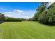 Expansive, well-maintained backyard with lush green lawn, perfect for recreation and outdoor activities at 7713 Still Lakes Dr, Odessa, FL 33556