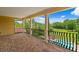 Covered balcony with wrought iron railing overlooking the pool and backyard at 7713 Still Lakes Dr, Odessa, FL 33556