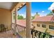 Balcony view showcases tile roofing, white columns, black iron railings, and outdoor seating at 7713 Still Lakes Dr, Odessa, FL 33556