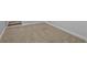 A finished basement with neutral carpeting and white trim at 7713 Still Lakes Dr, Odessa, FL 33556