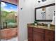 Bright bathroom with granite counters, sleek vanity, walk-in shower, and views of tropical foliage from the shower at 7713 Still Lakes Dr, Odessa, FL 33556