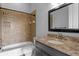 Cozy bathroom with tub and shower combination and granite vanity at 7713 Still Lakes Dr, Odessa, FL 33556