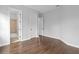 A bright bedroom with hardwood floors and access to a bathroom at 7713 Still Lakes Dr, Odessa, FL 33556
