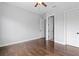 A modern bedroom with hardwood floors, ceiling fan, and neutral paint at 7713 Still Lakes Dr, Odessa, FL 33556