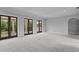 Large bonus room with neutral carpet and french doors with a balcony, perfect for entertaining at 7713 Still Lakes Dr, Odessa, FL 33556