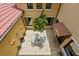 Aerial view of a private courtyard, with stucco walls, a fountain, wrought iron table, and awnings at 7713 Still Lakes Dr, Odessa, FL 33556