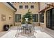 Charming outdoor patio area with a table and chairs surrounded by lush greenery at 7713 Still Lakes Dr, Odessa, FL 33556