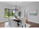 Elegant dining room with chandelier, large window, and seating for six at 7713 Still Lakes Dr, Odessa, FL 33556