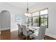 Bright dining room with chandelier, large window, and seating for six at 7713 Still Lakes Dr, Odessa, FL 33556