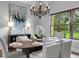 Elegant dining room with a large window offering scenic views and stylish decor at 7713 Still Lakes Dr, Odessa, FL 33556