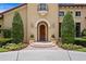 Charming front entrance with a wooden door, sidelights, and decorative planters at 7713 Still Lakes Dr, Odessa, FL 33556
