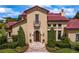 Charming front entrance with manicured landscaping and an elegant wooden door, creating a welcoming approach at 7713 Still Lakes Dr, Odessa, FL 33556