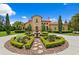 Stunning Mediterranean home with a circular driveway, fountain, and lush landscaping at 7713 Still Lakes Dr, Odessa, FL 33556
