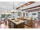 Open kitchen featuring stainless steel appliances, granite counters, and wood beams at 7713 Still Lakes Dr, Odessa, FL 33556