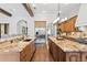 Gourmet kitchen featuring dual islands, custom cabinetry, and stainless steel appliances at 7713 Still Lakes Dr, Odessa, FL 33556