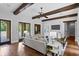 Spacious living room features wood beams, hardwood floors, and elegant furniture at 7713 Still Lakes Dr, Odessa, FL 33556