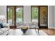 Cozy sitting area with view of outdoor pool and patio through large glass doors at 7713 Still Lakes Dr, Odessa, FL 33556