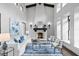 Inviting living room with soaring ceilings, a fireplace, and elegant furnishings at 7713 Still Lakes Dr, Odessa, FL 33556