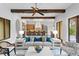 Open-concept living area with exposed beams offering a view of the kitchen and dining spaces at 7713 Still Lakes Dr, Odessa, FL 33556