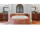 Elegant bathroom features a soaking tub, tiled surround, vanity with granite counters, and recessed lighting at 7713 Still Lakes Dr, Odessa, FL 33556