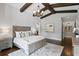 Serene main bedroom with exposed beams, a chandelier, and hardwood floors at 7713 Still Lakes Dr, Odessa, FL 33556