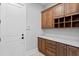 A large mud room with built-in cabinets, counter space, storage cubbies, and direct access to the exterior at 7713 Still Lakes Dr, Odessa, FL 33556