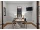 Well-lit home office space with a desk, chair, and shuttered windows at 7713 Still Lakes Dr, Odessa, FL 33556