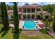 Stunning backyard pool and patio with a beautiful two-story home in the background at 7713 Still Lakes Dr, Odessa, FL 33556
