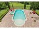 A stunning pool with brick patio, spa, and serene views of the manicured lawn at 7713 Still Lakes Dr, Odessa, FL 33556