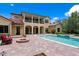 A stunning outdoor pool and patio area, perfect for relaxation and entertaining, with a cozy fire pit at 7713 Still Lakes Dr, Odessa, FL 33556