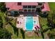 Aerial view of a beautiful pool and spa area with lounge chairs and manicured landscaping at 7713 Still Lakes Dr, Odessa, FL 33556